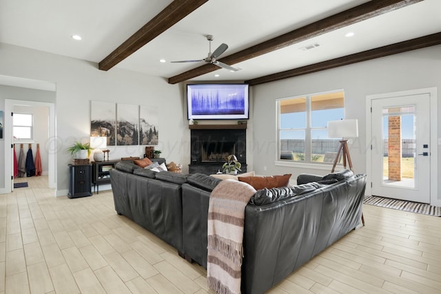 3851 Whitetail Springs Rd, Amarillo, TX 79119 - living room featuring beamed ceiling, a fireplace, a ceiling fan, and plenty of natural light