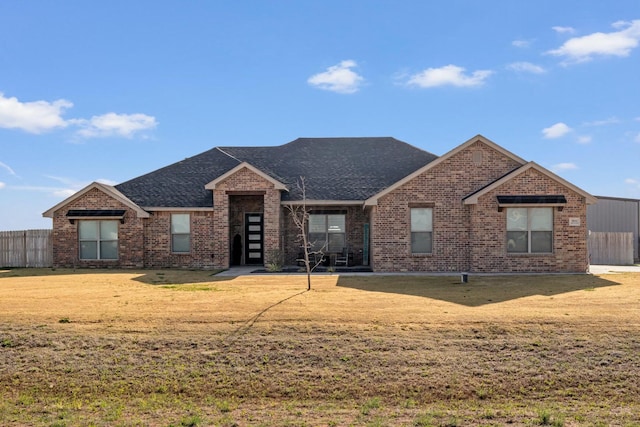 3851 Whitetail Springs Rd, Amarillo, TX 79119 - ranch-style house with brick siding, a front lawn, fence, and a shingled roof