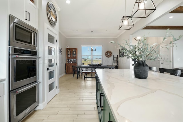 3851 Whitetail Springs Rd, Amarillo, TX 79119 - kitchen featuring white cabinetry, appliances with stainless steel finishes, a notable chandelier, and light stone counters