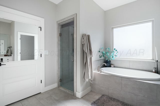 3851 Whitetail Springs Rd, Amarillo, TX 79119 - bathroom with tile patterned floors, a stall shower, baseboards, and a garden tub