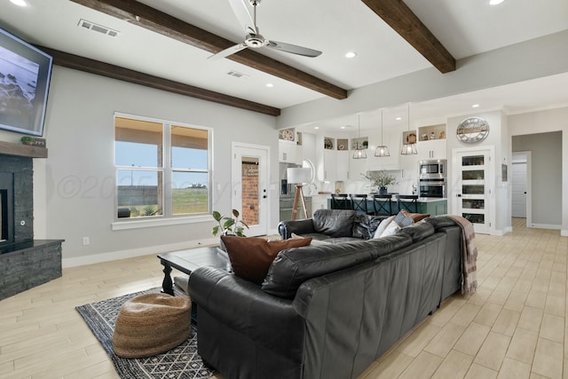 3851 Whitetail Springs Rd, Amarillo, TX 79119 - living room featuring a fireplace with raised hearth, visible vents, baseboards, and a ceiling fan