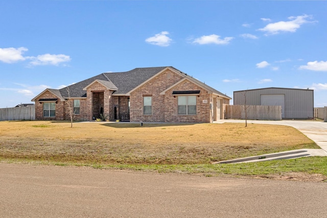 3851 Whitetail Springs Rd, Amarillo, TX 79119 - ranch-style home with an outdoor structure, driveway, brick siding, fence, and a shingled roof