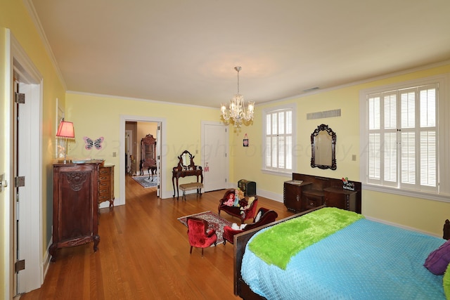 2101 S Harrison St, Amarillo, TX 79109 - bedroom with wood finished floors, a chandelier, ornamental molding, and baseboards