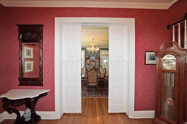 2101 S Harrison St, Amarillo, TX 79109 - hallway with a chandelier, wood finished floors, baseboards, crown molding, and wallpapered walls