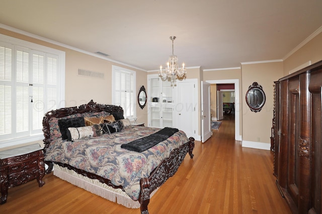2101 S Harrison St, Amarillo, TX 79109 - bedroom featuring wood finished floors, a chandelier, ornamental molding, and baseboards