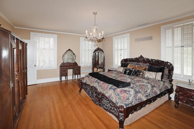 2101 S Harrison St, Amarillo, TX 79109 - bedroom with wood finished floors, a chandelier, multiple windows, and ornamental molding