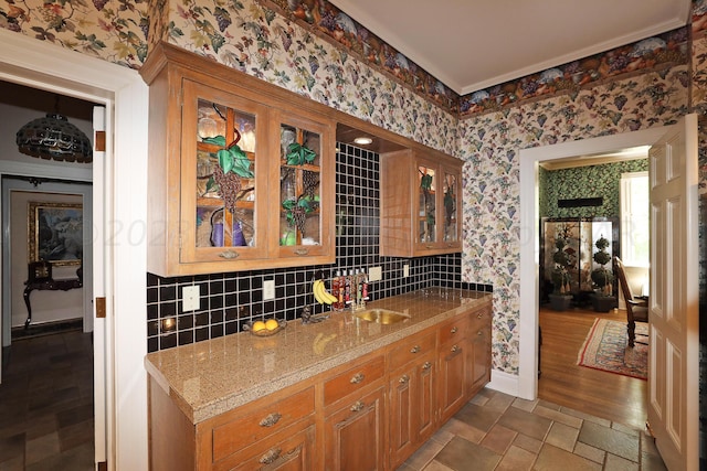 2101 S Harrison St, Amarillo, TX 79109 - kitchen with wallpapered walls, glass insert cabinets, backsplash, baseboards, and light stone counters