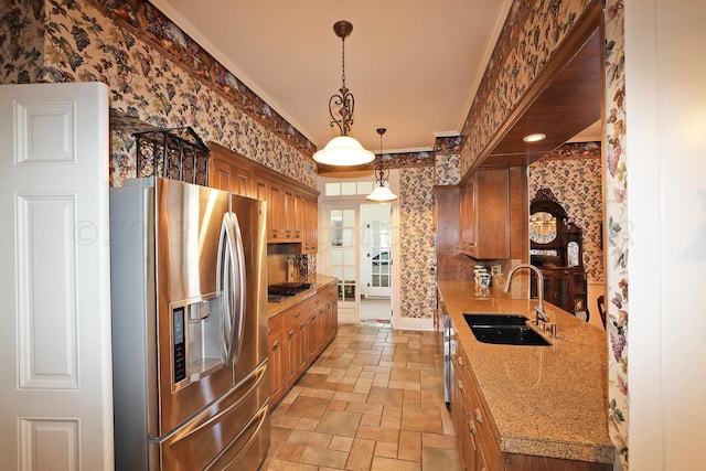 2101 S Harrison St, Amarillo, TX 79109 - kitchen with stainless steel fridge, a sink, wallpapered walls, stone tile floors, and light countertops