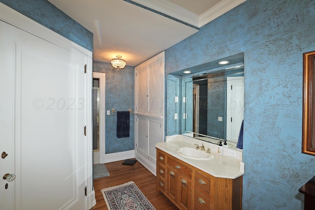 2101 S Harrison St, Amarillo, TX 79109 - bathroom with wood finished floors, vanity, wallpapered walls, baseboards, and ornamental molding