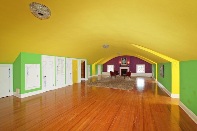 2101 S Harrison St, Amarillo, TX 79109 - additional living space with arched walkways, wood finished floors, lofted ceiling, and baseboards