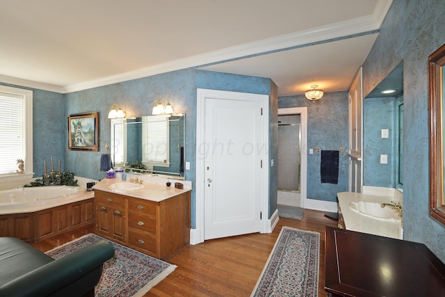 2101 S Harrison St, Amarillo, TX 79109 - full bathroom with wallpapered walls, wood finished floors, a stall shower, a bath, and two vanities