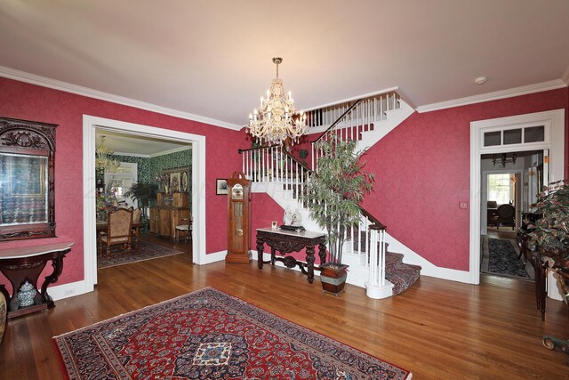 2101 S Harrison St, Amarillo, TX 79109 - foyer featuring stairway, a chandelier, baseboards, wood finished floors, and ornamental molding