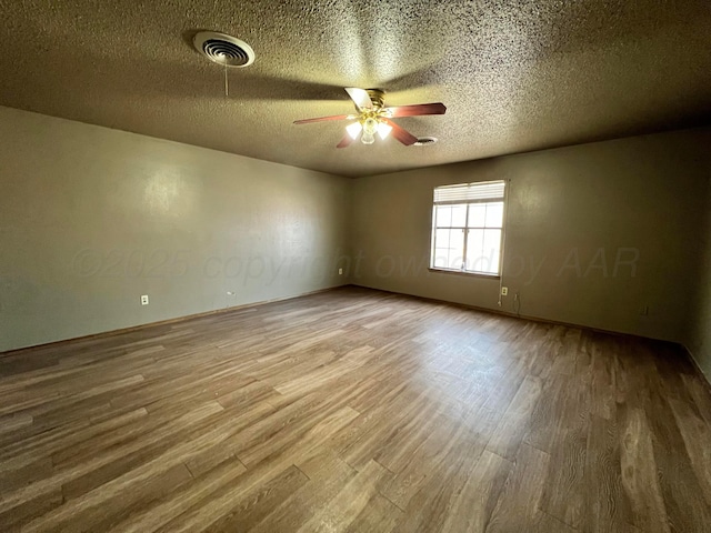 empty room with wood-type flooring, a textured ceiling, and ceiling fan