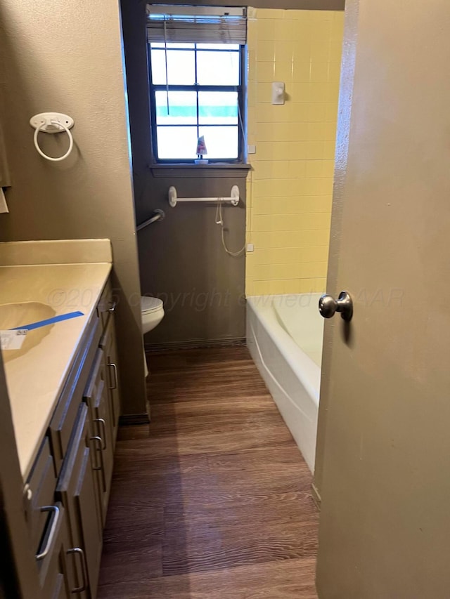 bathroom featuring vanity, hardwood / wood-style floors, and toilet