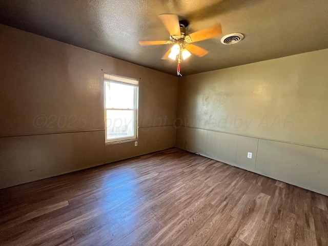 unfurnished room with hardwood / wood-style floors, a textured ceiling, and ceiling fan