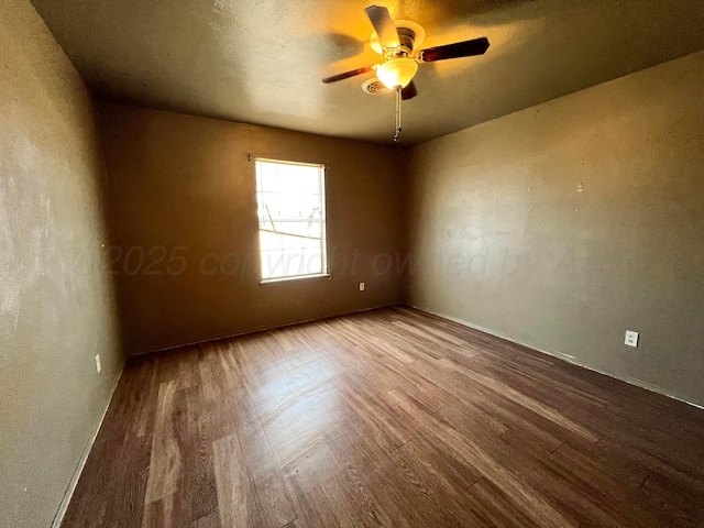 empty room with hardwood / wood-style floors and ceiling fan