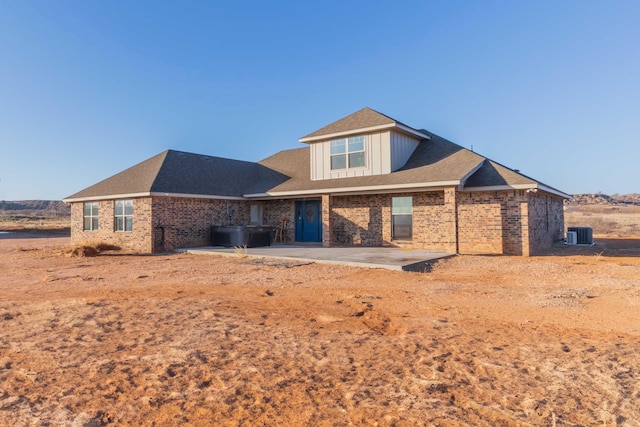 view of front of property with central AC and a patio area