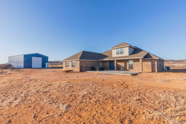 back of house with a garage and an outdoor structure