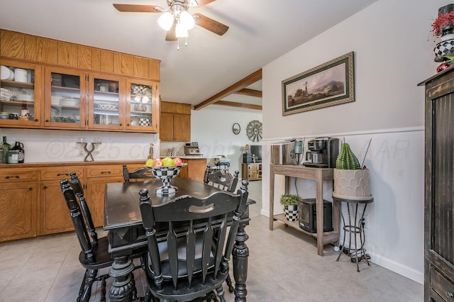 dining area featuring beam ceiling, a ceiling fan, and light tile patterned flooring