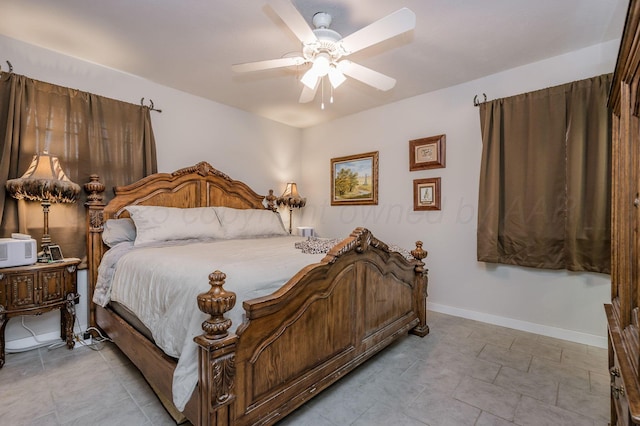 bedroom with baseboards and a ceiling fan