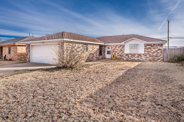 ranch-style house with brick siding, concrete driveway, an attached garage, and fence