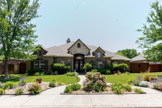 7809 Clearmeadow Dr, Amarillo, TX 79119 - french country inspired facade with stone siding and a chimney