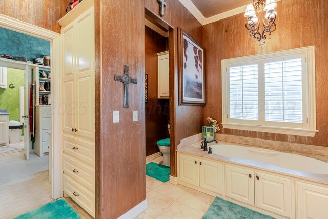 7809 Clearmeadow Dr, Amarillo, TX 79119 - bathroom with crown molding, a garden tub, a chandelier, toilet, and a closet