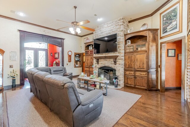7809 Clearmeadow Dr, Amarillo, TX 79119 - living room featuring a ceiling fan, crown molding, wood finished floors, a stone fireplace, and baseboards