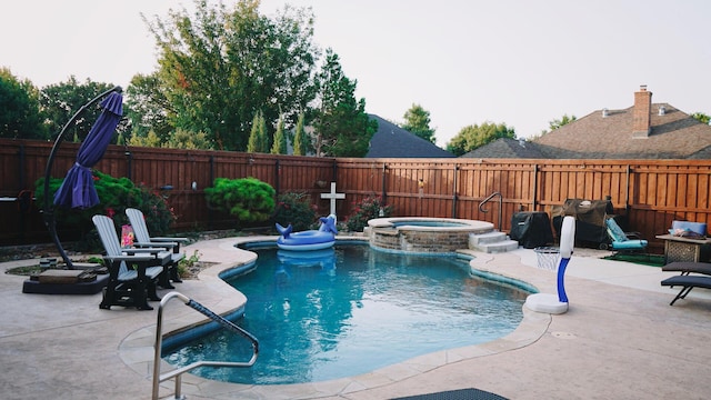 view of pool with a patio and an in ground hot tub