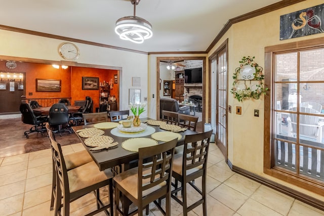 7809 Clearmeadow Dr, Amarillo, TX 79119 - dining room featuring ornamental molding, light tile patterned floors, a fireplace, ceiling fan, and baseboards
