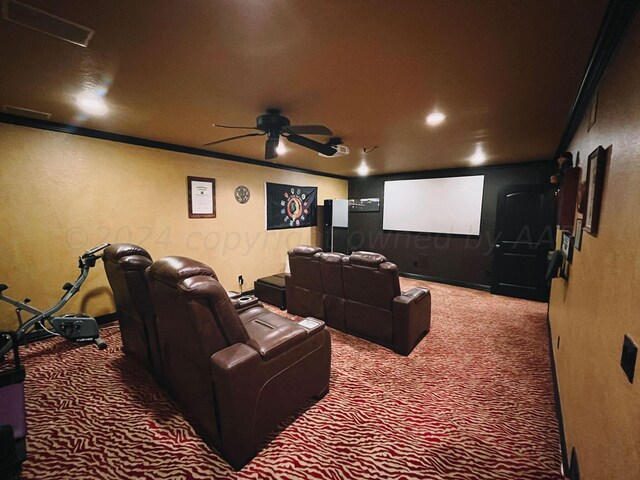 home theater room with ornamental molding, carpet floors, and ceiling fan