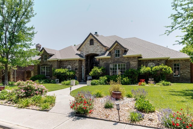 7809 Clearmeadow Dr, Amarillo, TX 79119 - french provincial home with a front yard, a chimney, and a shingled roof