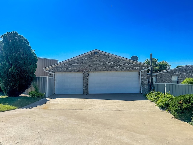 311 Jennie Ln, Borger, TX 79007 - garage featuring fence and driveway