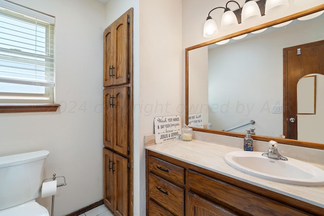 bathroom featuring toilet, vanity, and tile patterned flooring