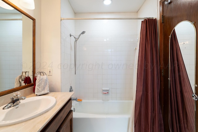 bathroom featuring shower / tub combo and vanity