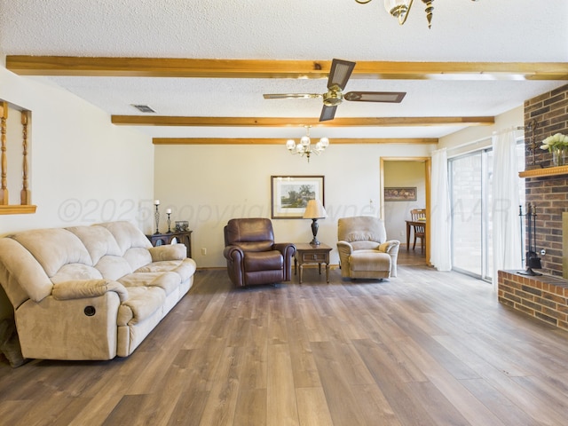 1620 N Nelson St, Pampa, TX 79065 - living room with beam ceiling, wood finished floors, a chandelier, a textured ceiling, and a fireplace