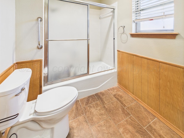 1620 N Nelson St, Pampa, TX 79065 - full bath featuring shower / bath combination with glass door, wood walls, and a wainscoted wall
