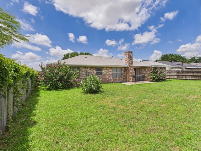 1620 N Nelson St, Pampa, TX 79065 - rear view of property featuring a patio area, a fenced backyard, a chimney, and brick siding