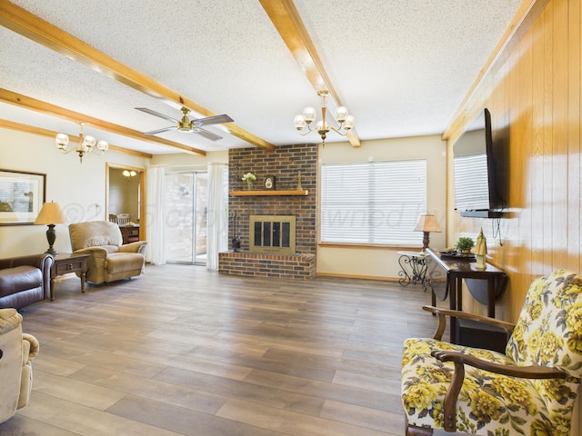 1620 N Nelson St, Pampa, TX 79065 - living room featuring a chandelier, a textured ceiling, beamed ceiling, wooden walls, and ceiling fan