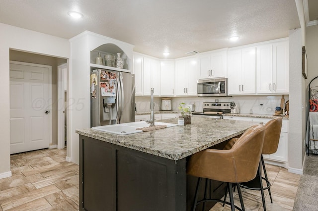 8309 City View Dr, Amarillo, TX 79118 - kitchen featuring appliances with stainless steel finishes, white cabinetry, open shelves, recessed lighting, and light stone counters