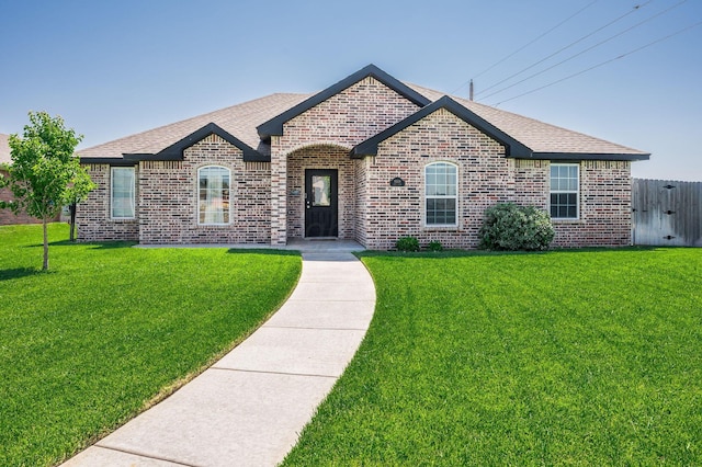 8309 City View Dr, Amarillo, TX 79118 - french provincial home with brick siding, a front lawn, and a shingled roof