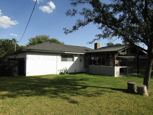 back of property with a gazebo and a yard