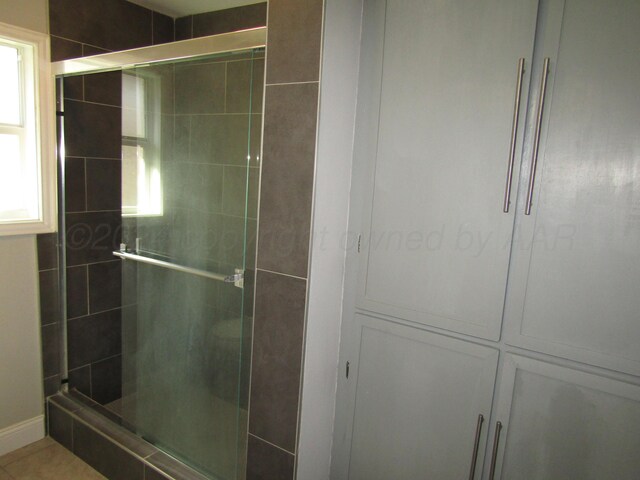 bathroom featuring a shower with door