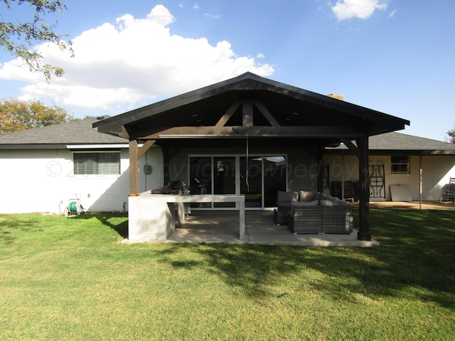 back of property featuring an outdoor hangout area, a patio area, and a lawn