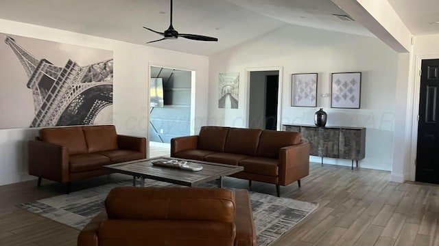 living room featuring vaulted ceiling, ceiling fan, and hardwood / wood-style floors