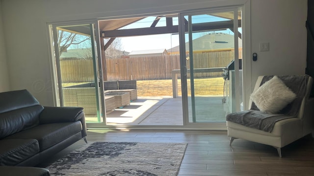 doorway to outside with hardwood / wood-style flooring and a healthy amount of sunlight