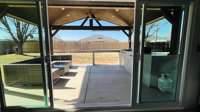 doorway to outside featuring vaulted ceiling and floor to ceiling windows