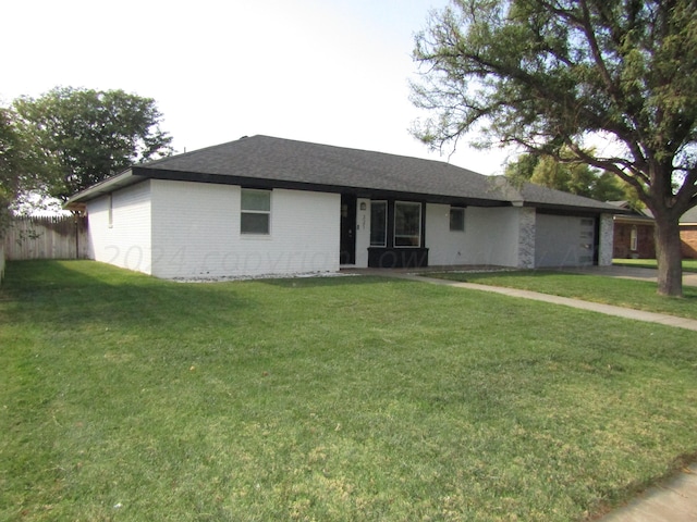 ranch-style house featuring a garage and a front yard