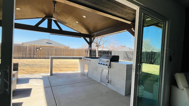 view of patio / terrace with ceiling fan and area for grilling