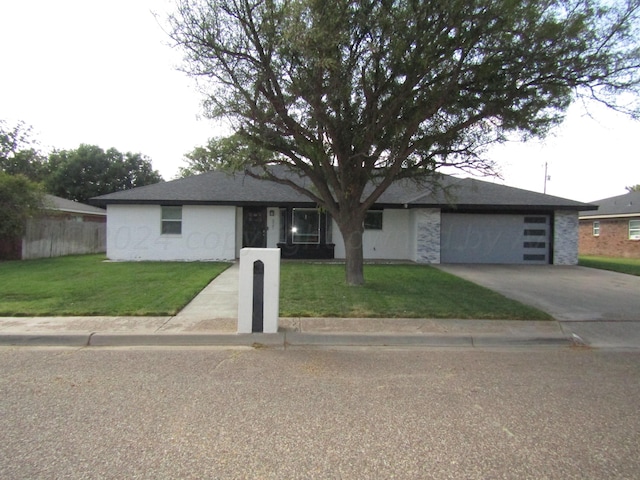 ranch-style house featuring a garage and a front yard